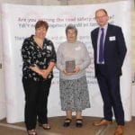 Pictured is Daisy Lambe receiving her Road Safety Wales Award from Sue Storch, Chair of Road Safety Wales, and Chris Hume from Go Safe (and Deputy Chair of Road Safety Wales).