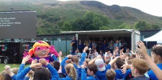 Pupils are on song to celebrate Welsh Language Charter success / Disgyblion yn canu i ddathlu llwyddiant y Siarter Iaith Gymraeg Pupils watch a performance by Mr Phormula