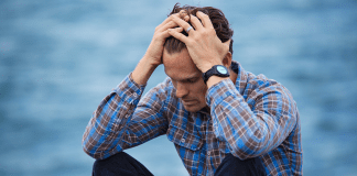 How to Deal with Grief for the 1st Time man in blue and brown plaid dress shirt touching his hair 897817
