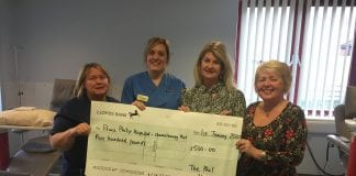 Phil Harmonics Choir donate £500 to the Chemotherapy Day Unit at Prince Philip Hospital Pictured Kim Stockwell Staff Nurse Sarah Mair Richards and Sharon Griffiths scaled
