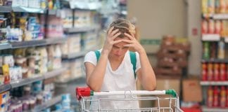 MOST UK CHILDREN ‘A PAY CHEQUE AWAY’ FROM GOING WITHOUT ESSENTIALS LIKE FOOD Supermarket girl with shopping trolley