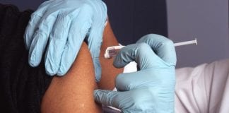Lib Dems urge early deployment of Covid vaccine throughout West Wales including Pembrokeshire to protect the most vulnerable nurse administers a vaccine