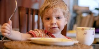 KEY WORKERS WARN FAMILY FINANCES SET TO WORSEN THROUGH WINTER, AS WELSH PARENTS STRUGGLE TO FEED AND CLOTHE THEIR CHILDREN a child looks at the camera over a plate mobile
