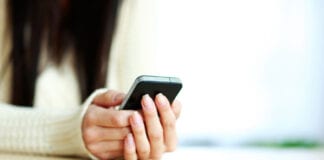 LGA responds to latest test and trace figures Woman with mobile 1
