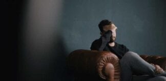 LGA responds to latest suicide statistics and reports Sad man on sofa