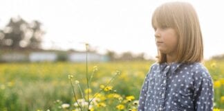 Bouncing Back building resilience in our young people in Wales Young girl standing in field of flowers looki.width 1000