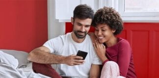 VALENTINES DAY: BRITS MORE IN LOVE WITH THEIR HOMES THAN PARTNERS 0 couple holding phone