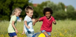 LGA responds to roadmap exit delay 1 girl and 2 boys playing with a ball in a field 941 x 627