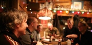 Too many pubs push down house prices People sitting in pub 1