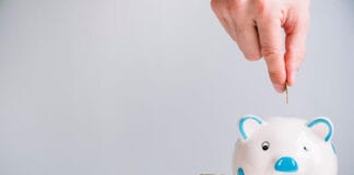 How to raise money savvy kids, directly from expert human hand inserting coin piggybank