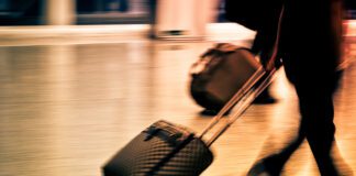 Travel industry reacts to latest foreign travel changes s960 passenger carrying suitcase airport 960
