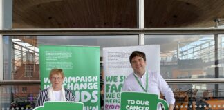 JOYCE RAISES A MUG IN SUPPORT OF MACMILLAN’S COFFEE MORNING Joyce Richard Pugh @ Macmillan event scaled