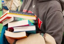 compass girl with stack of books