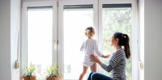 28% of Brits spending less time together as a family since lockdown restrictions lifted alpha boilers woman and baby at window scaled