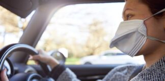 Reduced driving during pandemic has led to increase in anxious drivers young woman wearing protective mask driving car royalty free image 1589988464