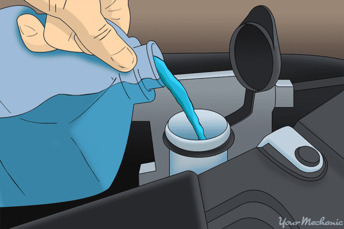 How to Diagnose and Repair a Faulty Windshield Washer Pump 1 Hand pouring blue washing solution in open washer reservoir