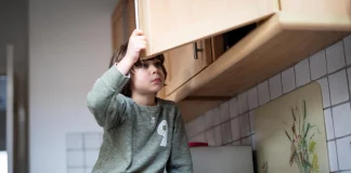 RCPCH calls for Government action following latest child poverty statistics young boy looking in cupboard