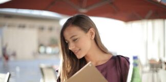 10 Menu Tricks Restaurants Are Using to Get You to Spend More woman reading a menu min