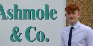 Ashmole & Co celebrate successful completion of Apprenticeship Rhys Ibbitson outside Ammanford office scaled
