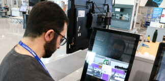 Paperless shop floor becomes an AMRC first 1 Anmar Al Qutayri senior manufacturing research engineer at AMRC Cymru pictured with the interlinked touch screen kiosk which houses all of the necessary documents needed on the shop floor. scaled