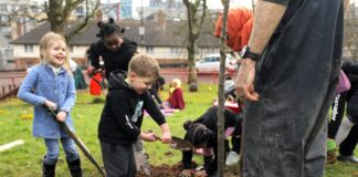New partnership project will put local communities at the heart of efforts to protect and restore nature in Wales Children bedding in a newly planted apple tree s Credit Rob Carmier rspb images.com