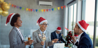 4 ways to motivate employees during the festive season playful business colleagues having fun christmas party office scaled