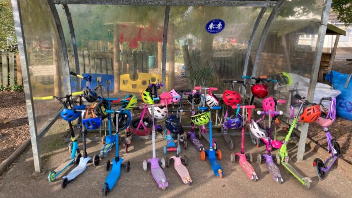Scooters in a shelter outside of Ysgol Gymunedol Penrhyn coch in Aberystwyth.