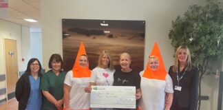 Grŵp o ffrindiau yn gwisgo fel conau traffig yn ystod taith gerdded noddedig Susan Partridge Leach