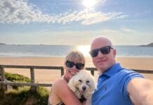 Survivor Who Thought She Was ‘Cancer Proof’ Supports Stripe A Pose 2025 Rachel with husband Dean and her dog Sheldon